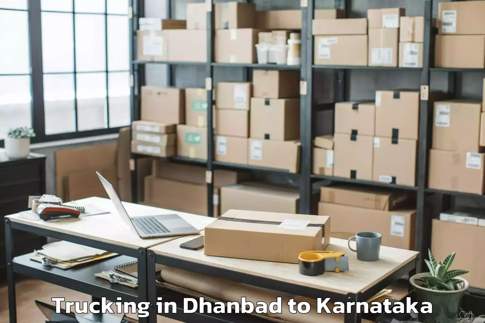 Book Dhanbad to Karnataka State Rural Developm Trucking Online